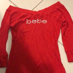 Red off shoulder Bebe shirt. Cute rhinestones.